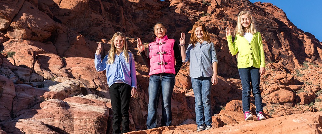 Girl Scouts share the Girl Scout Sign, an important tradition A group of Girl Scouts embrace tradition