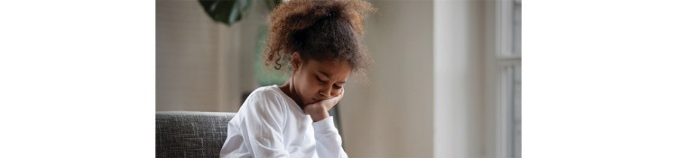 Girl in white shirt resting her head on her hand looking anxious and depressed Girl in white shirt resting her head on her hand looking anxious and depressed