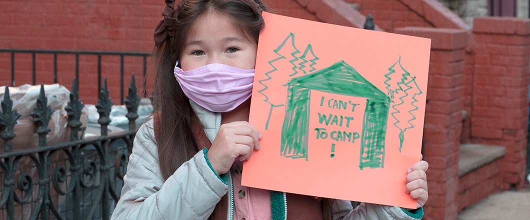 Girl Scout holding a handmade sign that says: I can't wait for camp! Girl Scout holding a handmade sign that says: I can't wait for camp!